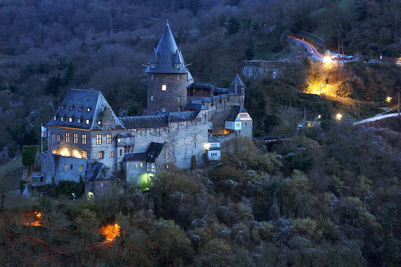 Stahleck Castle at dusk — Bertram Nudelbach, CC BY-SA 2.0 Stahleck Castle illuminated at dusk above the Rhine.