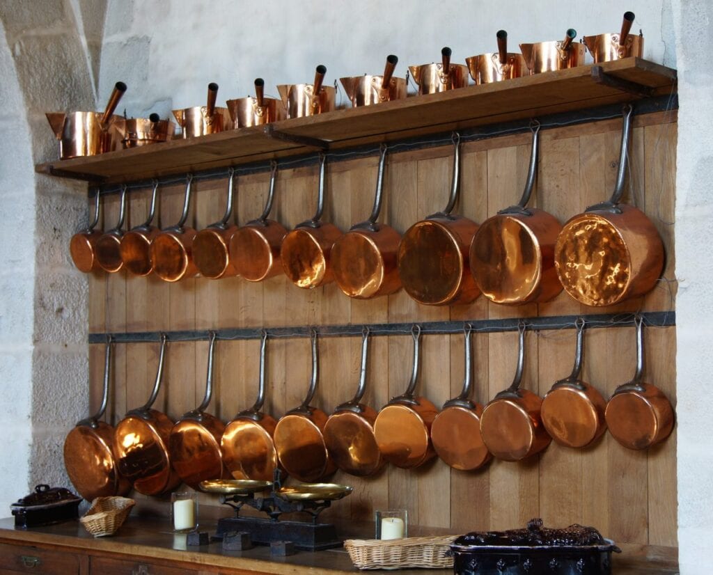 Rows of copper pans on the kitchen wall at Vaux-le-Vicomte