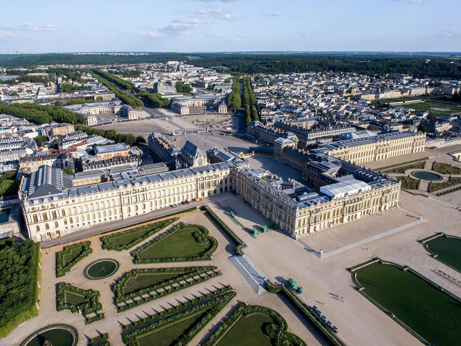 Palace of Versailles 1 Aerial view of the Palace of Versailles, its forecourt, and the gardens reaching toward the Grand Canal