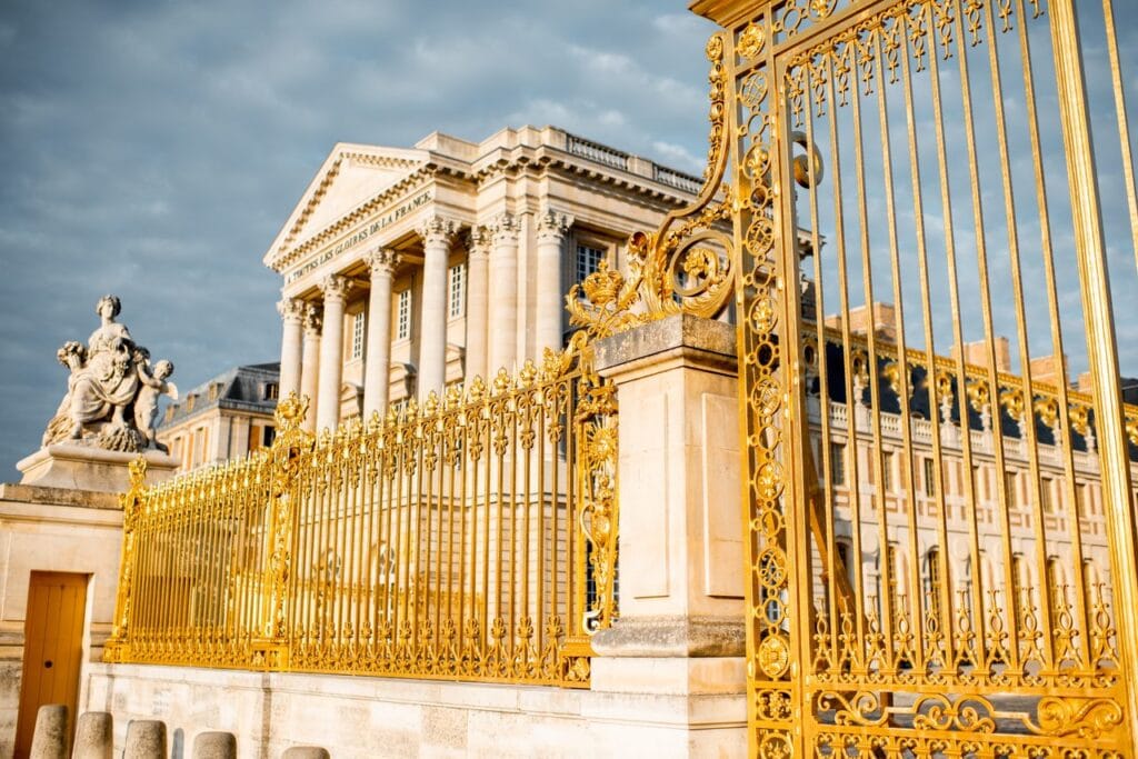 Palace of Versailles 19 The gilded gate of Versailles with the pediment inscription A toutes les gloires de la France behind it