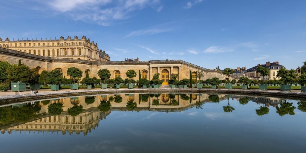Palace of Versailles 16 The Orangery at Versailles reflected in a still garden pool