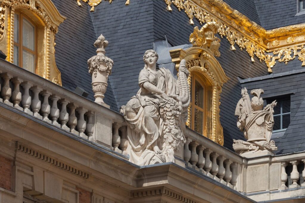 Palace of Versailles 18 Gilded rooftop statuary and trophies along the roofline of the Palace of Versailles