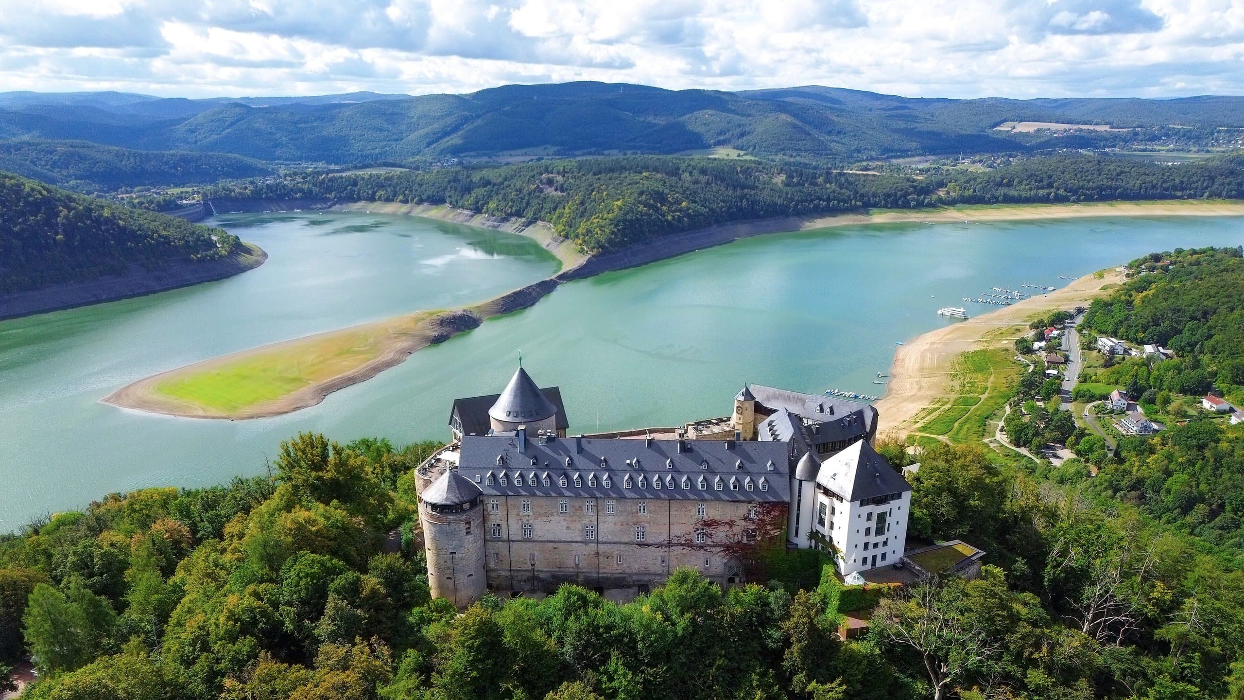 Aerial view of Waldeck Castle on its wooded promontory above the Edersee reservoir