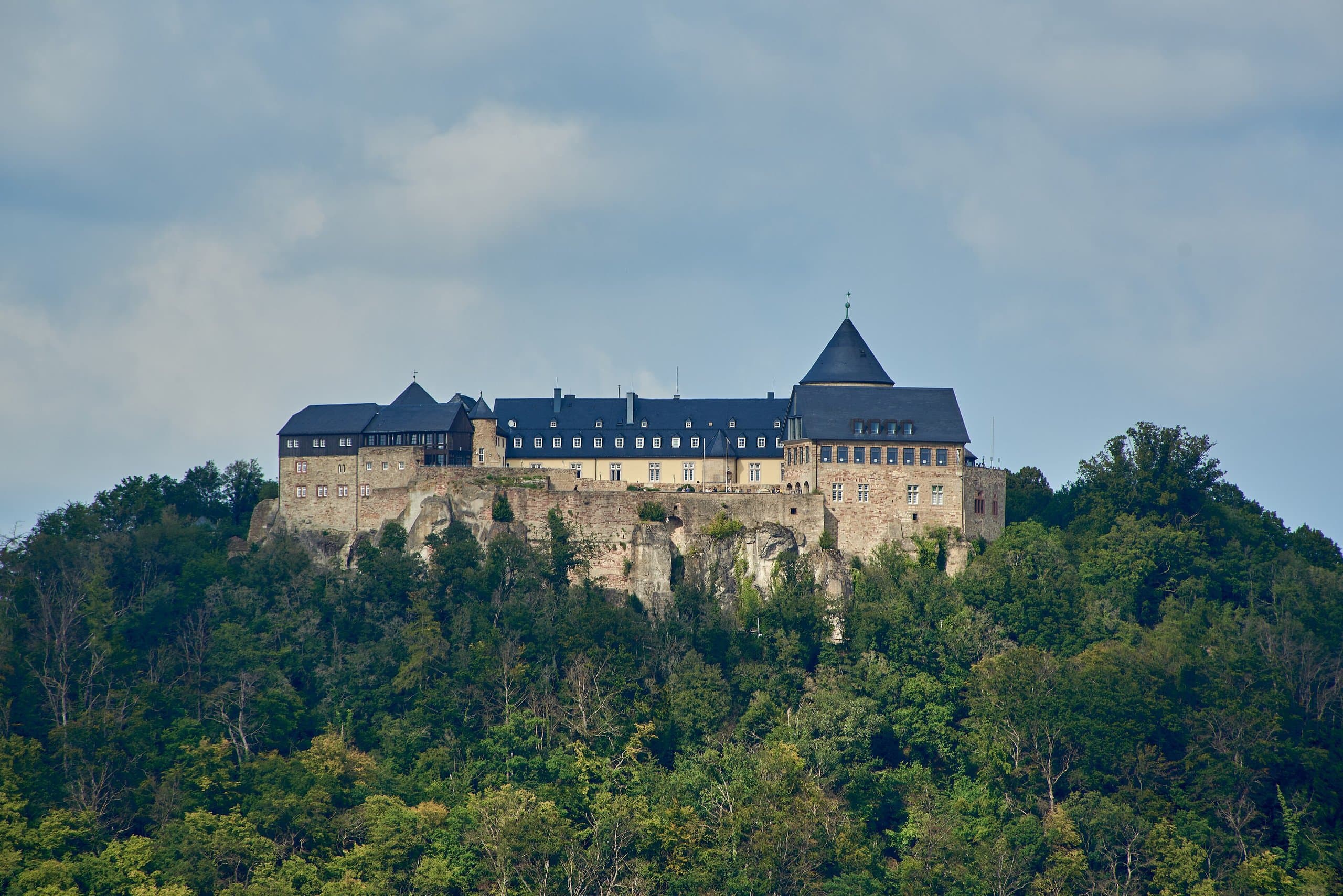 Waldeck Castle seen from the south, its keep and ranges rising above the forest