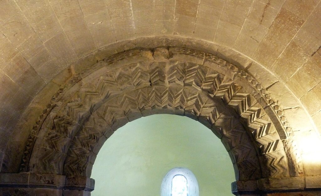 Edinburgh Castle 10 Detail of the Romanesque chancel arch in St Margaret's Chapel, its voussoirs cut with bold zig-zag chevron ornament.