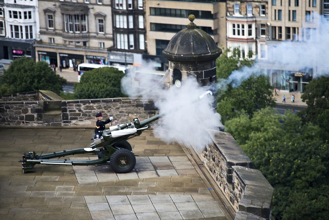 The One O'Clock Gun fires from Mills Mount Battery in a cloud of smoke, the castle's daily one o'clock time signal over the city. The One O'Clock Gun fires from Mills Mount Battery in a cloud of smoke, the castle's daily one o'clock time signal over the city.