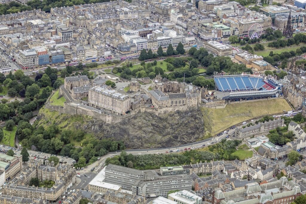 Edinburgh Castle 2 An aerial view of Edinburgh Castle spread along the summit of Castle Rock, the Esplanade and its Tattoo grandstand at the near end and Princes Street beyond.