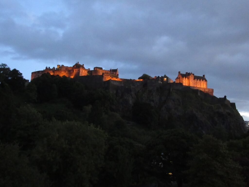 Edinburgh Castle 9 Edinburgh Castle floodlit at dusk on its crag, the Royal Palace and Half Moon Battery glowing above the darkened city.