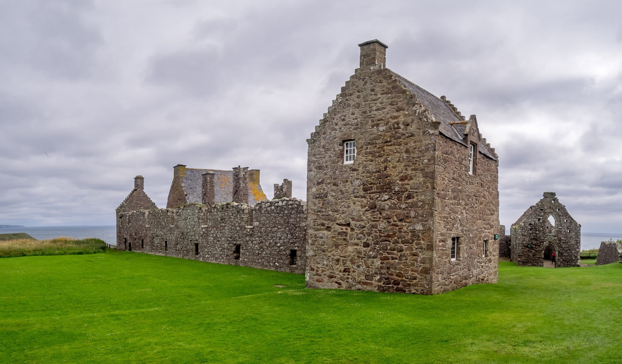 The palace quadrangle of the Earls Marischal at Dunnottar Castle, a roofed lodging block, ranges, and the gabled chapel enclosing a grassy court. The palace quadrangle of the Earls Marischal at Dunnottar Castle, a roofed lodging block, ranges, and the gabled chapel enclosing a grassy court.