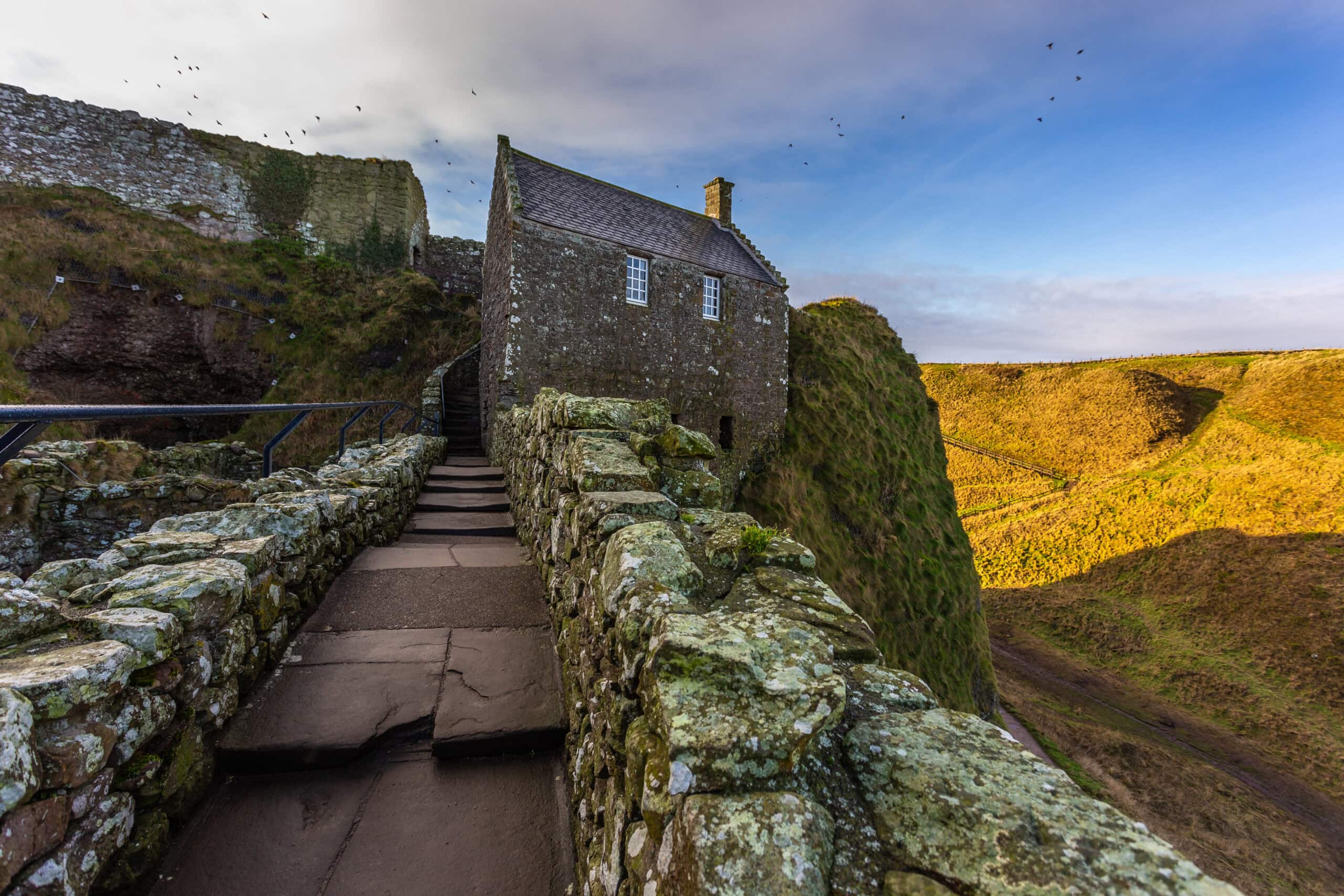 The stepped path climbing to the tunnel-like entrance beneath Benholm's Lodging at Dunnottar Castle. The stepped path climbing to the tunnel-like entrance beneath Benholm's Lodging at Dunnottar Castle.