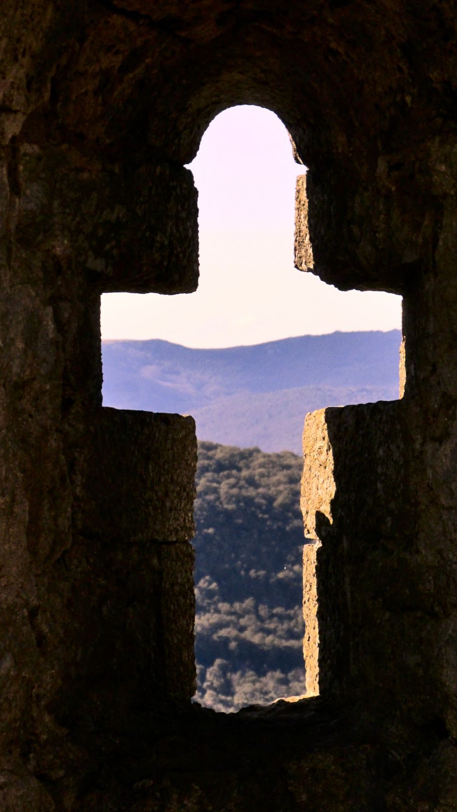 The cross-shaped chapel window at the Château de Termes The cross-shaped chapel window at the Château de Termes