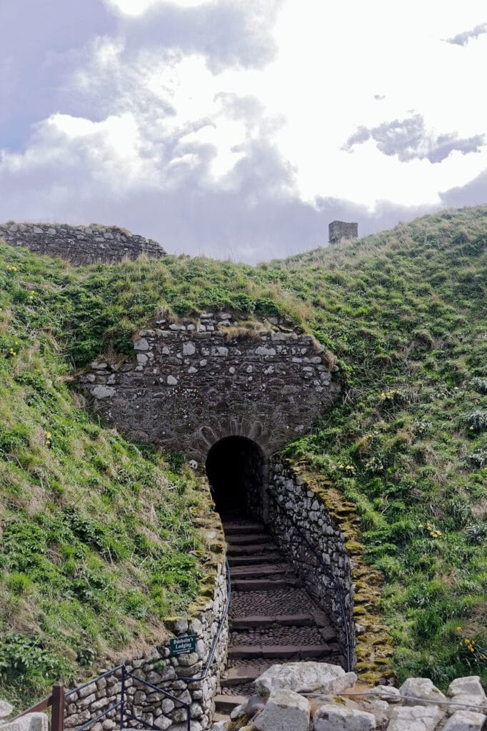 Dunnottar Castle 5 Stone stair rising to a dark arched tunnel entrance cut into the cliff below Benholm's Lodging at Dunnottar Castle.