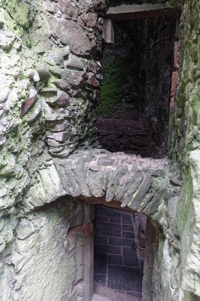 Dunnottar Castle 6 Stone steps descending into a dark vaulted lower chamber within Dunnottar Castle.