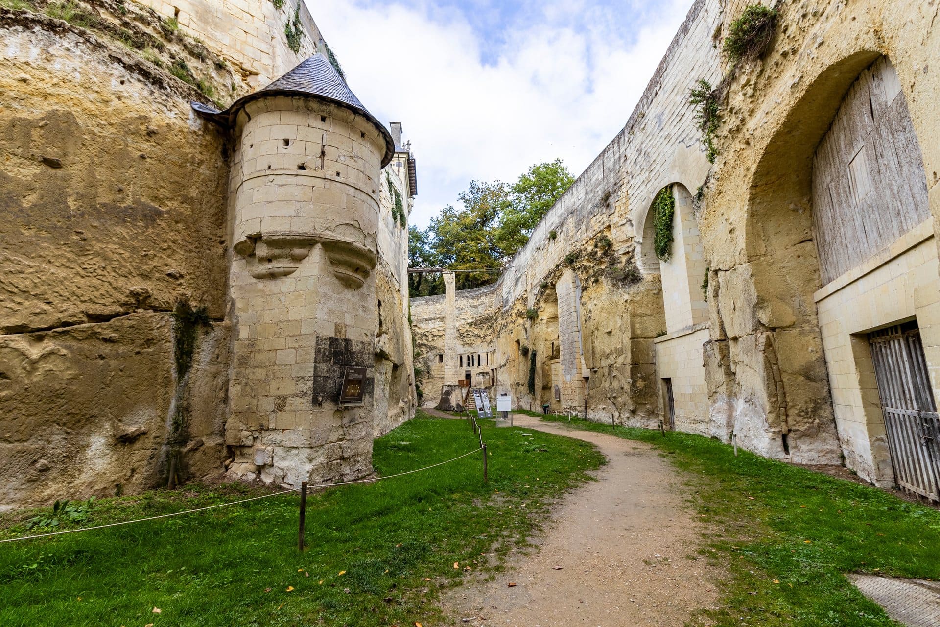 A tower rising from the dry moat of Château de Brézé