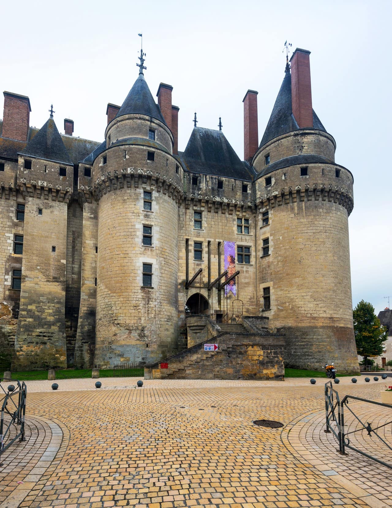 The twin round towers and working drawbridge of the town front, the fortress face Louis XI turned toward the street. Photo: Viacheslav Lopatin / Adobe Stock. The twin round towers and working drawbridge of the town front, the fortress face Louis XI turned toward the street. Photo: Viacheslav Lopatin / Adobe Stock.