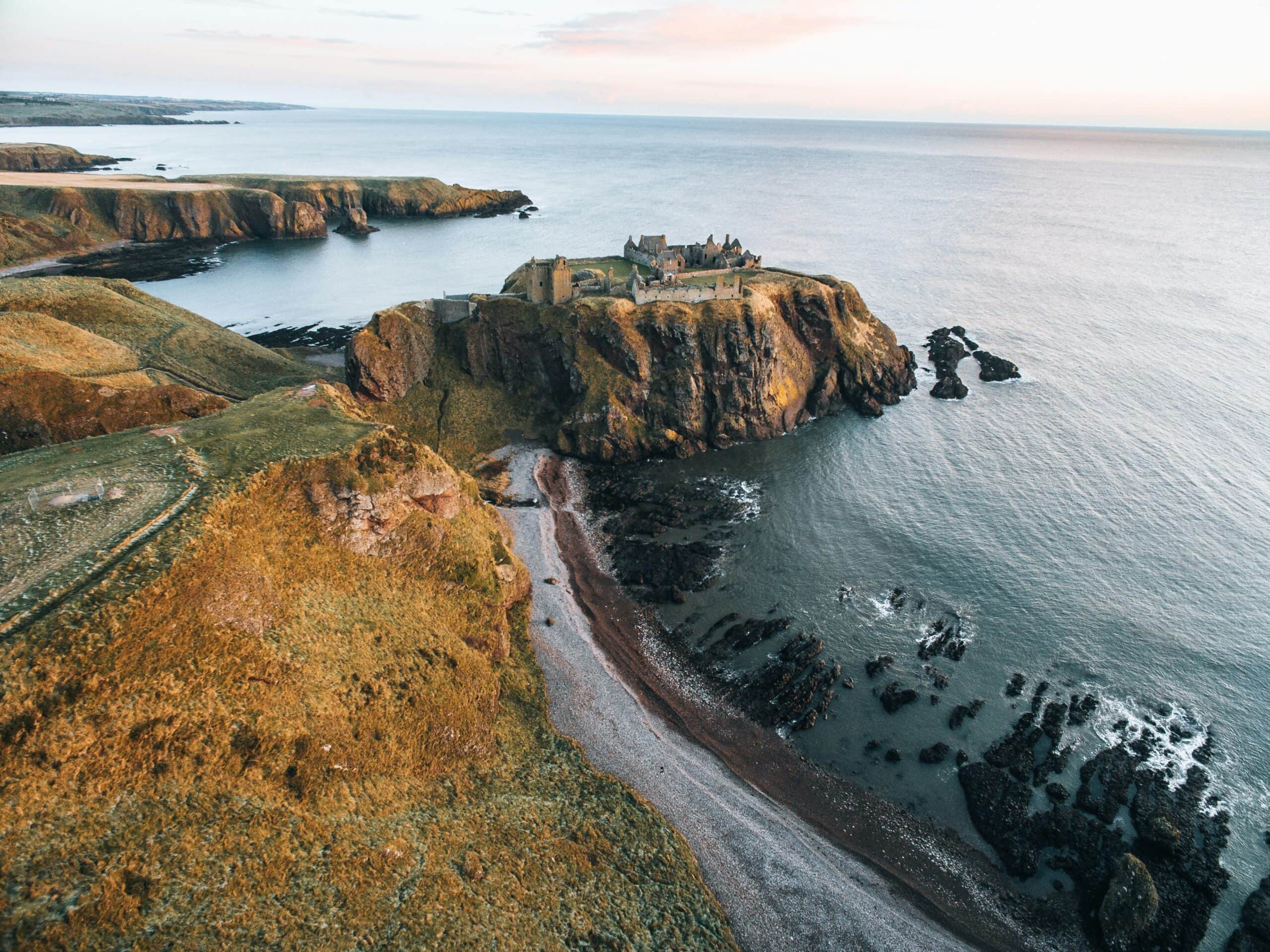 Evening light on the roofless ranges of Dunnottar Castle seen from the landward cliffs. Evening light on the roofless ranges of Dunnottar Castle seen from the landward cliffs.