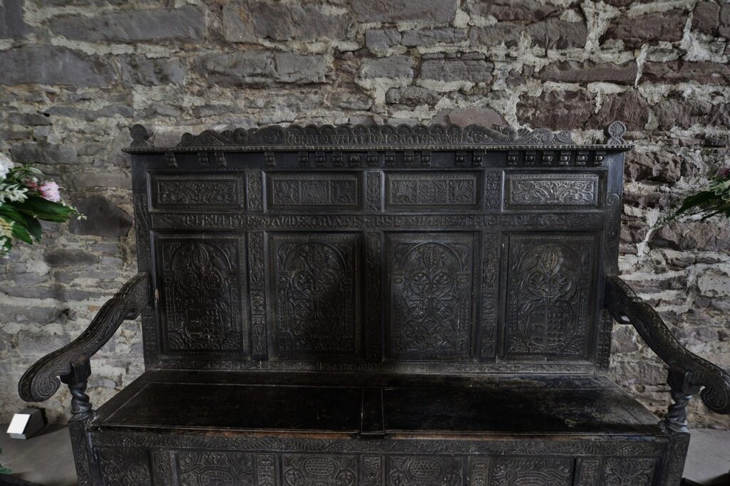 A carved oak settle on display at Doune Castle
