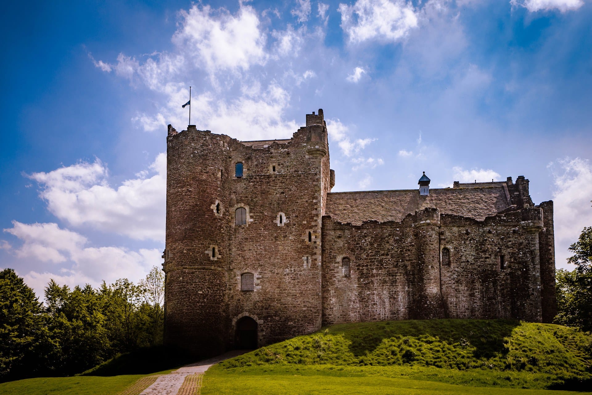 Doune Castle's entrance front, with the great gatehouse tower on the left and the long hall range to the right.