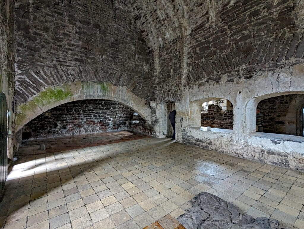 The vaulted kitchen at Doune Castle with its wide fireplace