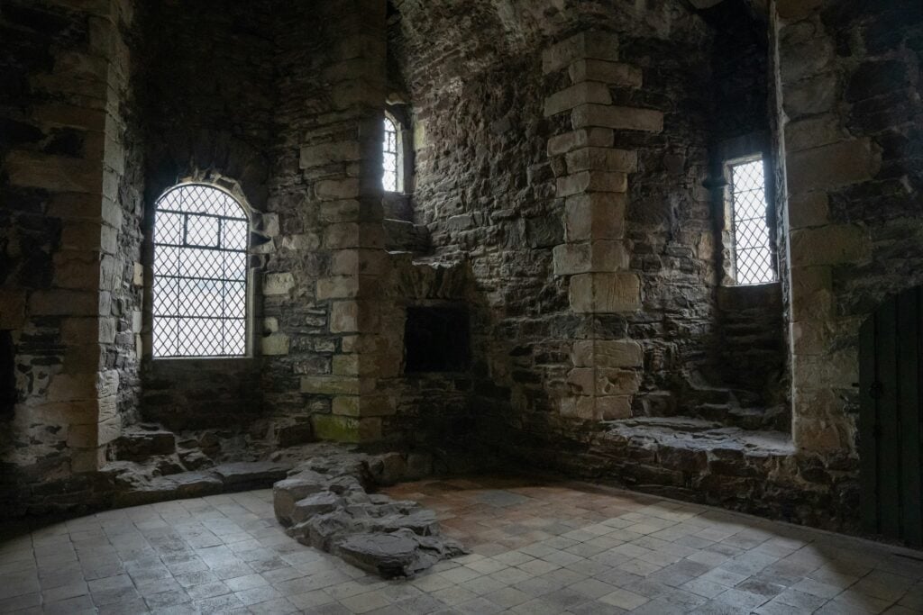 A vaulted chamber at Doune Castle with diamond-leaded windows