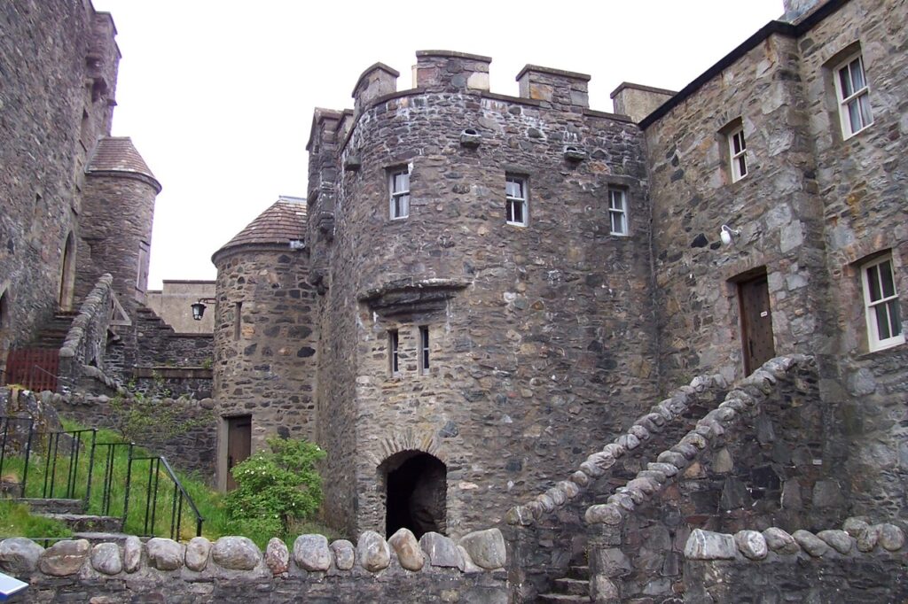 Eilean Donan Castle 3 Inside the walls, a round battlemented flanking tower and a stone stair rise over the small courtyard garden.