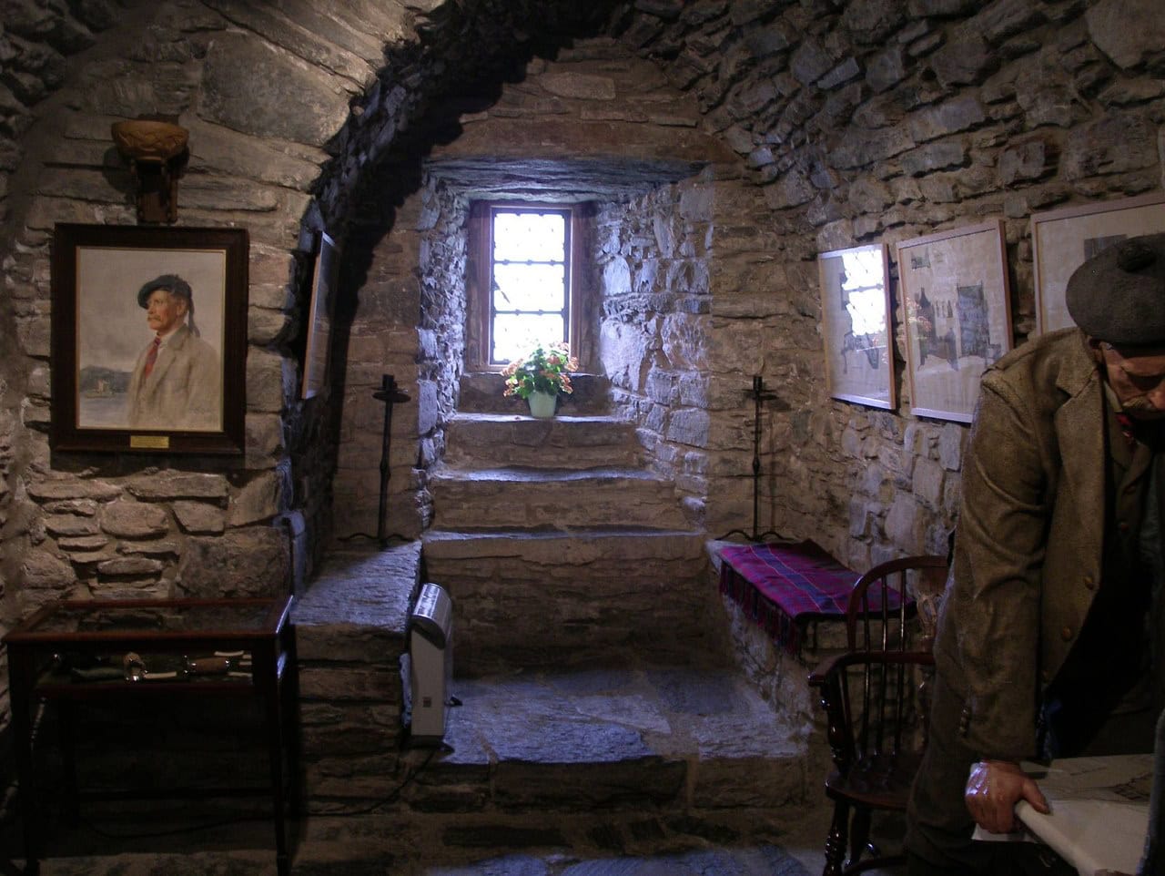 A vaulted stone chamber inside the castle, restored and furnished in the early 20th century, lit by a single deep-set window. A vaulted stone chamber inside the castle, restored and furnished in the early 20th century, lit by a single deep-set window.