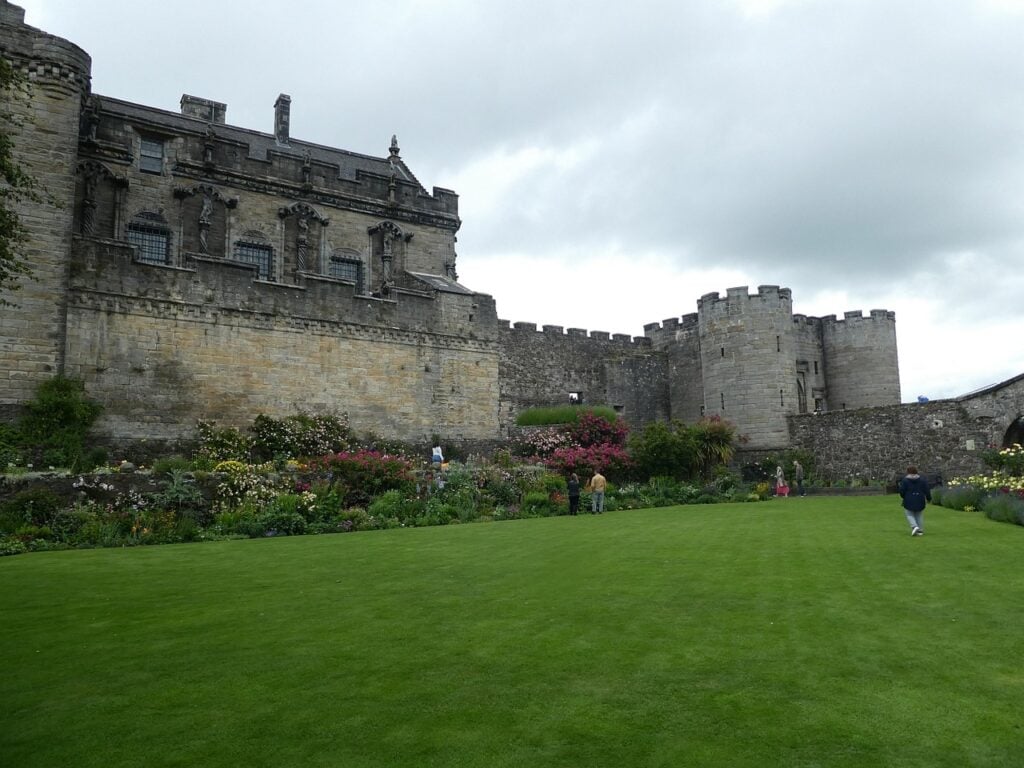 Stirling Castle 8 The Queen Anne Garden, a sheltered lawn and herbaceous borders beneath the palace facade and a gatehouse drum tower.