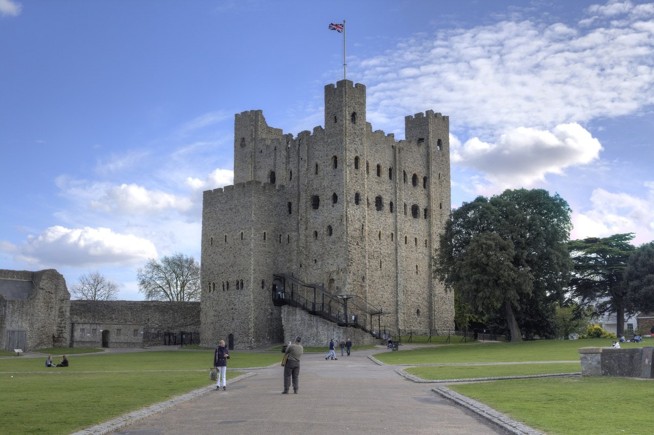 The tall square Norman keep of Rochester Castle from the northwest, with corner turrets, a forebuilding and visitors on the lawn for scale. The tall square Norman keep of Rochester Castle from the northwest, with corner turrets, a forebuilding and visitors on the lawn for scale.