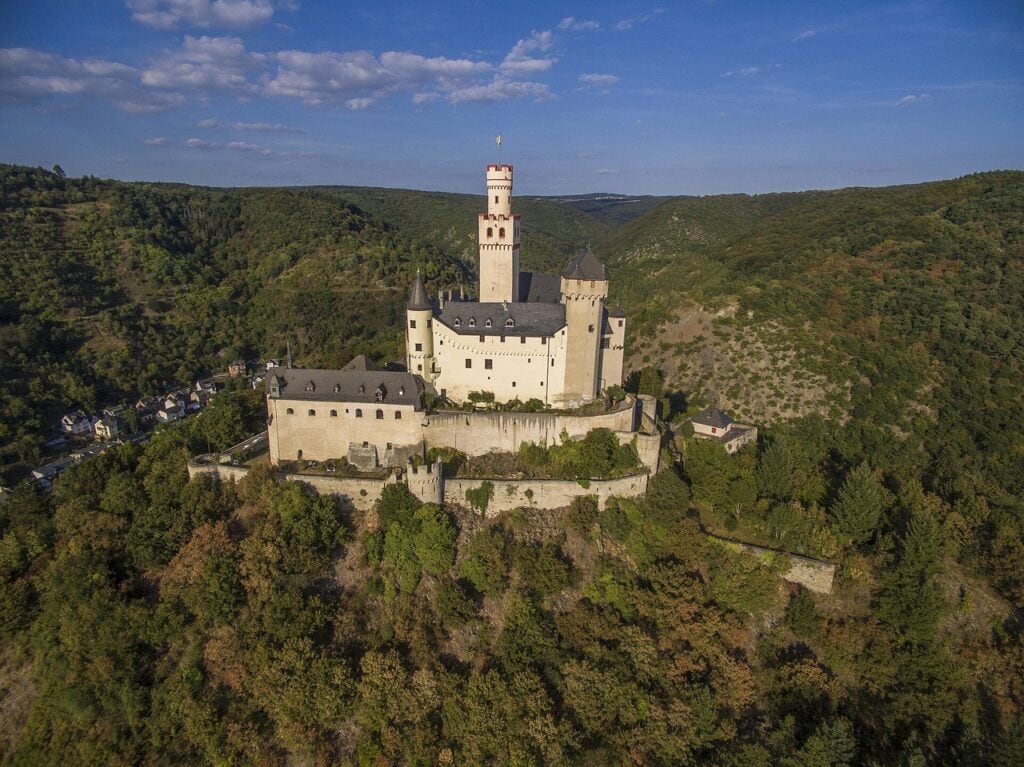 Aerial view of Marksburg filling the crown of its wooded hill
