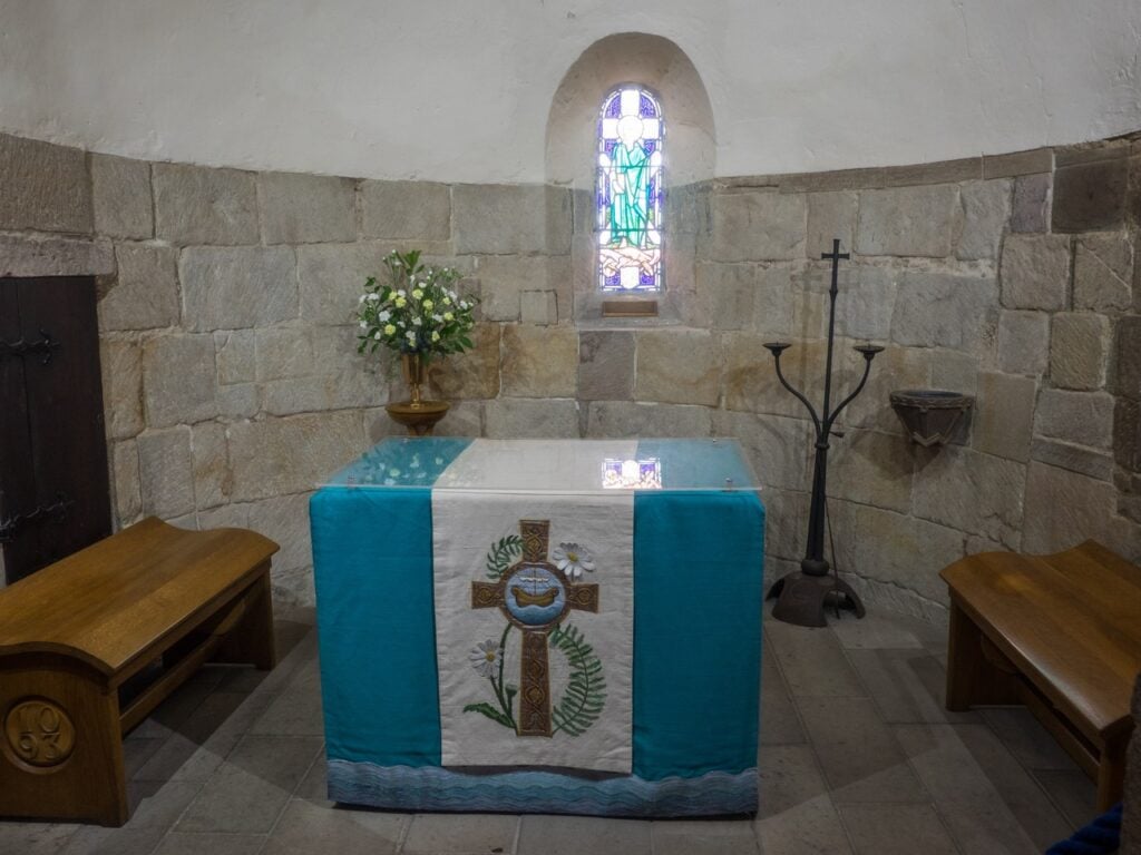 Edinburgh Castle 13 Inside St Margaret's Chapel, Edinburgh's oldest surviving building, the apse holds a simple altar beneath a stained-glass window.