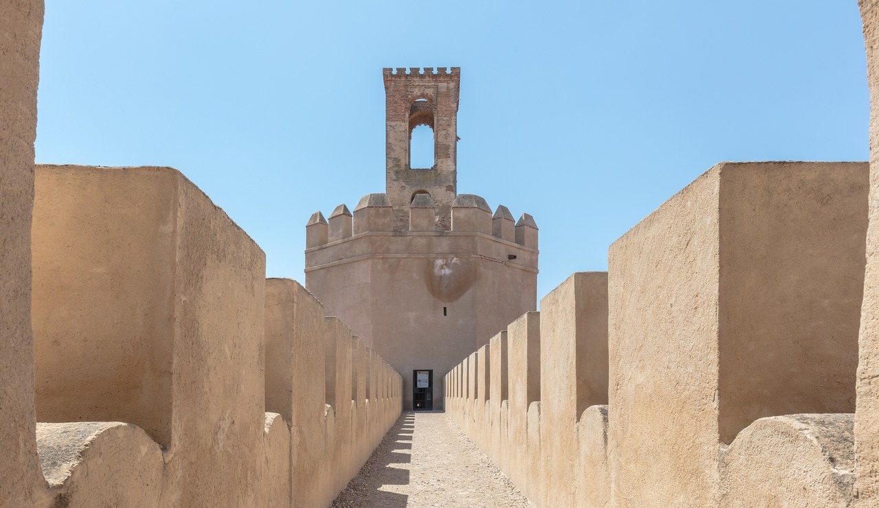 A tall tower standing beyond the castle wall at Badajoz, reached by a narrow crenellated walkway running out to it from the curtain. A tall tower standing beyond the castle wall at Badajoz, reached by a narrow crenellated walkway running out to it from the curtain.