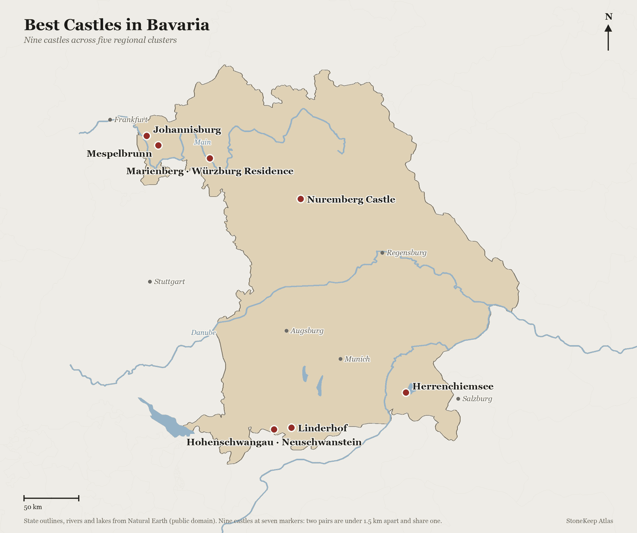 Locator map of Bavaria showing the nine castles in this guide at seven markers: Johannisburg and Mespelbrunn in the northwest, Marienberg and the Würzburg Residence sharing one marker at Würzburg, Nuremberg Castle in the centre, Hohenschwangau and Neuschwanstein sharing one marker in the Alpine foothills with Linderhof just east of them, and Herrenchiemsee on the Chiemsee in the southeast. The Main and the Danube are traced, and Munich, Augsburg, Regensburg, Frankfurt, Stuttgart and Salzburg are marked for orientation.