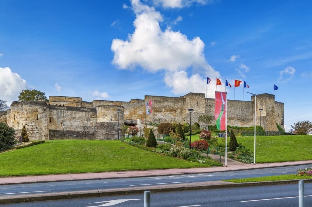 Château de Caen 3 The long south curtain wall of the Château de Caen above a planted bank, seen from the street below.