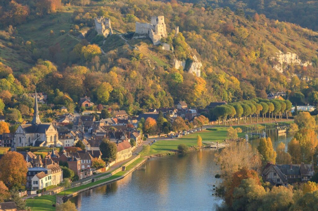 Château Gaillard 8 Autumn view across the Seine to Le Petit-Andely, with Château Gaillard small on the wooded ridge above the town.