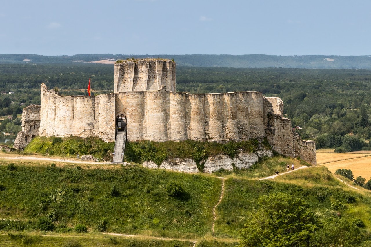 The lobed outer face of Château Gaillard's inner curtain wall, a run of shallow cylinder segments above the ditch, with a modern access stair rising to the gate at left. The lobed outer face of Château Gaillard's inner curtain wall, a run of shallow cylinder segments above the ditch, with a modern access stair rising to the gate at left.