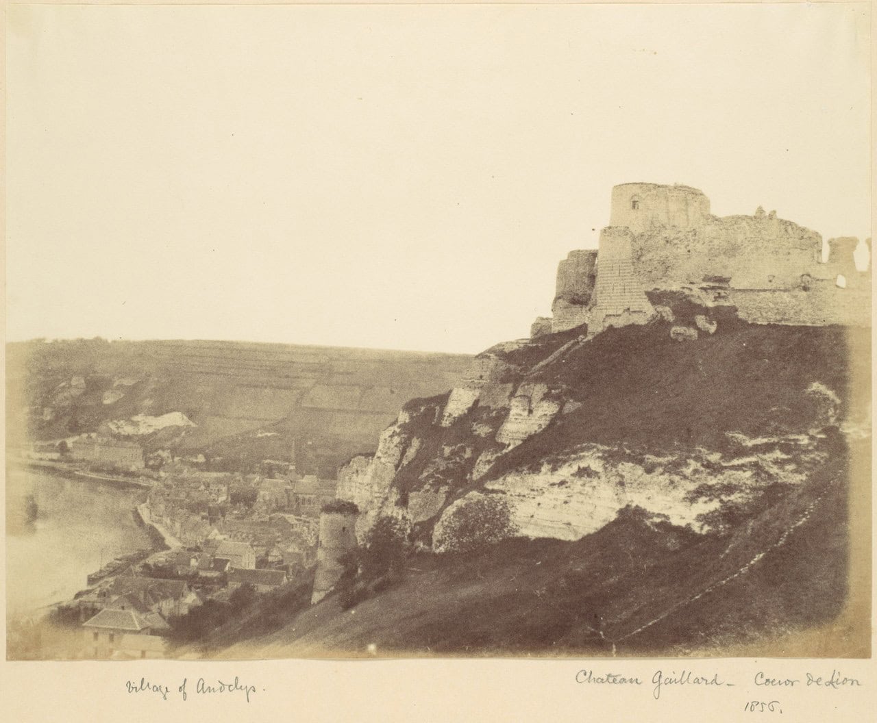 A sepia salt print photograph of the 1850s showing the ruins of Château Gaillard on their chalk hillside above the roofs of Le Petit-Andely and the Seine. A sepia salt print photograph of the 1850s showing the ruins of Château Gaillard on their chalk hillside above the roofs of Le Petit-Andely and the Seine.