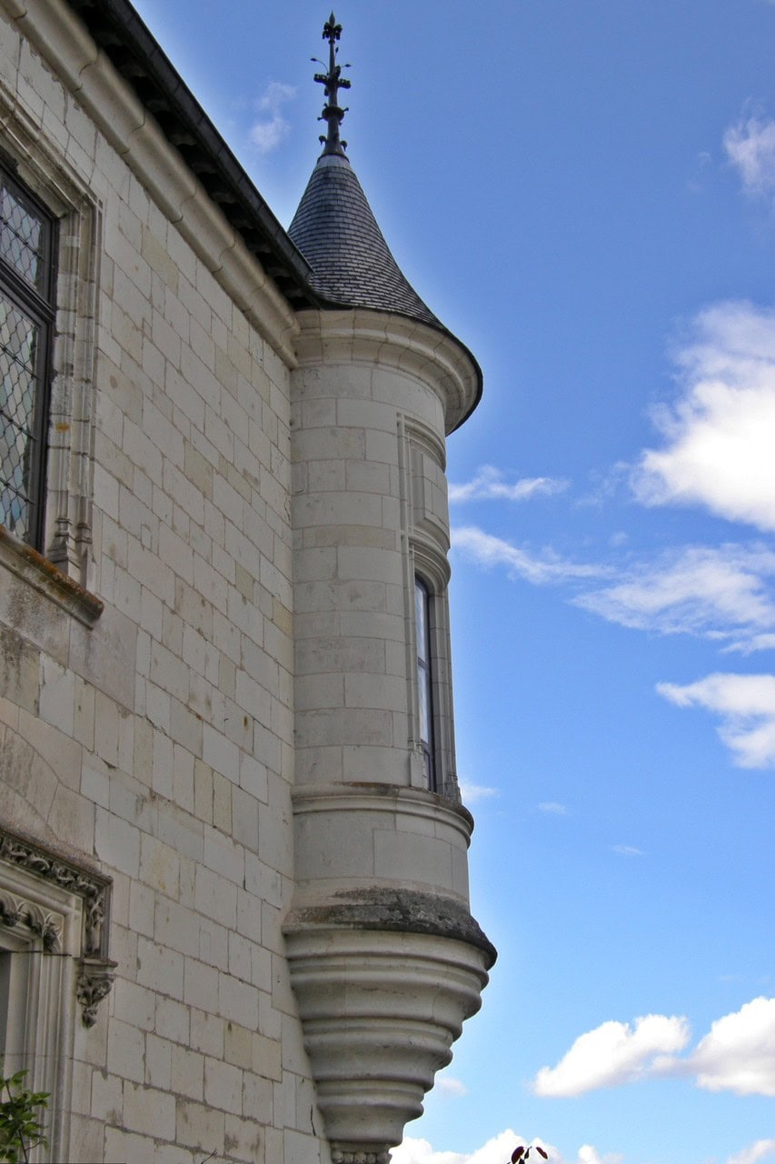 A small round turret projecting from the corner of a pale stone range at the Château de Chaumont-sur-Loire, carried on a moulded conical corbel that stops well above the ground, with a tall window slot in its face and a conical slate roof topped by an ironwork finial. A small round turret projecting from the corner of a pale stone range at the Château de Chaumont-sur-Loire, carried on a moulded conical corbel that stops well above the ground, with a tall window slot in its face and a conical slate roof topped by an ironwork finial.