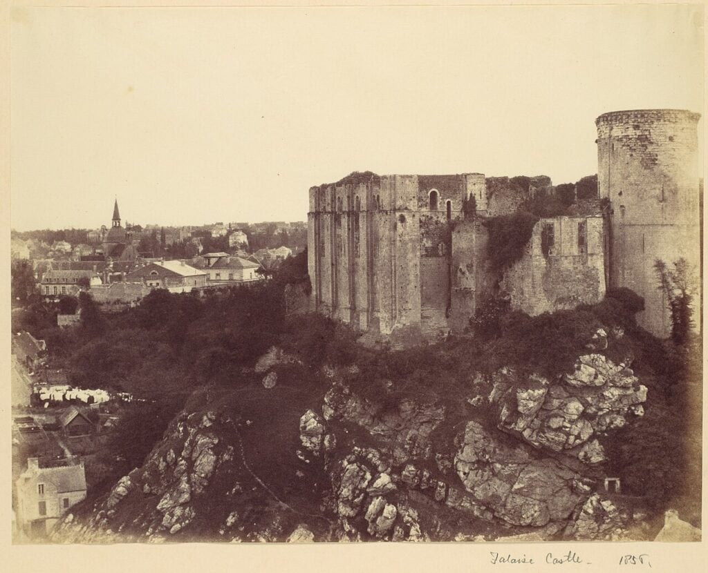 Château de Falaise 12 An 1856 photograph of Chateau de Falaise, the keep and round tower standing roofless on the rock with trees growing from the walls and the roofs of the town below.