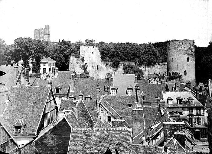 A black and white photograph of about 1920 looking over the roofs of Gisors to the castle on its height, the octagonal keep at the left. A black and white photograph of about 1920 looking over the roofs of Gisors to the castle on its height, the octagonal keep at the left.