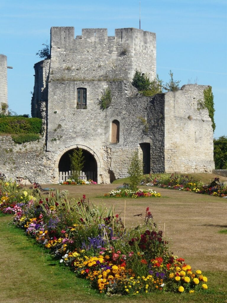 Château de Gisors 3 The crenellated gatehouse at Chateau de Gisors rising beyond a long border of marigolds and dahlias.