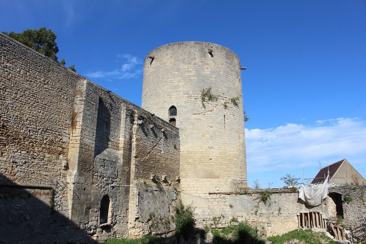 The cylindrical ashlar great tower of Chateau de Gisors rising above a rubble curtain wall, seen from outside the enclosure. The cylindrical ashlar great tower of Chateau de Gisors rising above a rubble curtain wall, seen from outside the enclosure.