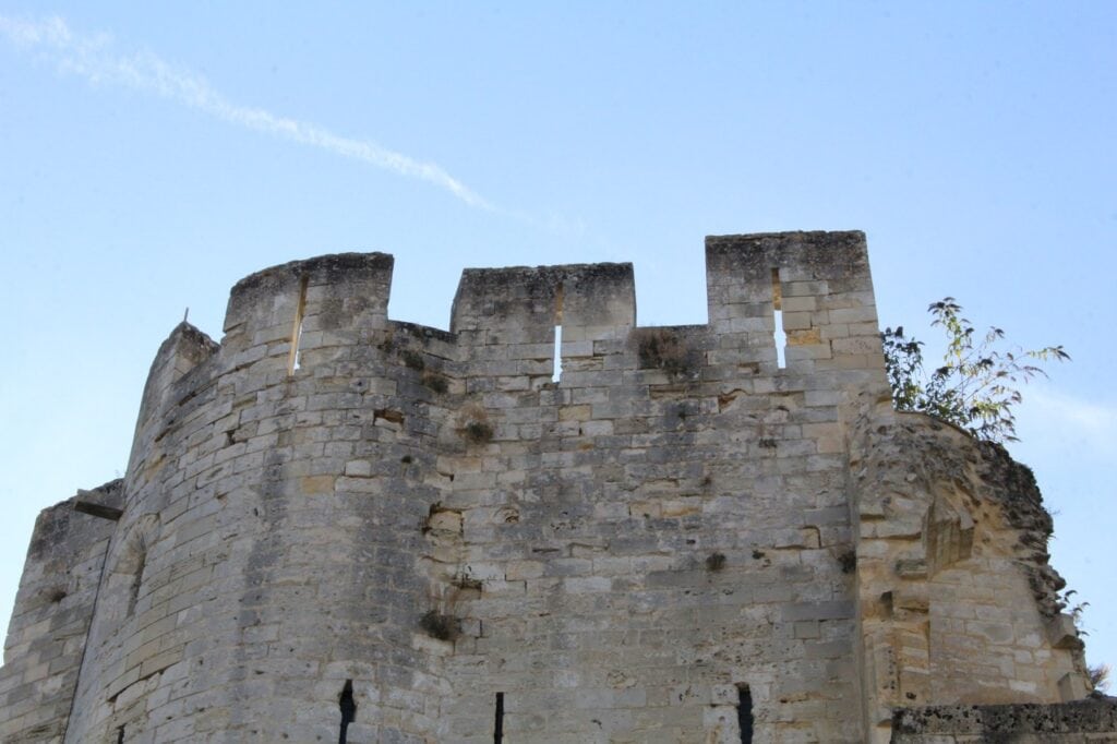 Château de Gisors 13 The crenellated parapet of the gatehouse at Chateau de Gisors, its merlons pierced with narrow vertical slits.