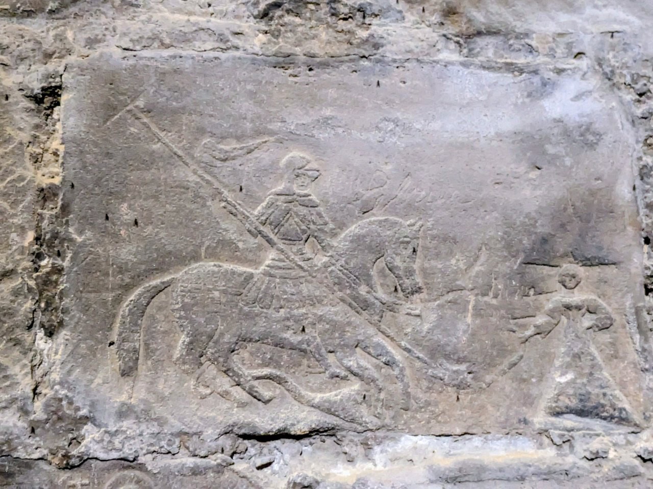 A relief carving of a man on horseback with a lance over his shoulder, cut into a wall block in the Prisoner's Tower at Chateau de Gisors. A relief carving of a man on horseback with a lance over his shoulder, cut into a wall block in the Prisoner's Tower at Chateau de Gisors.