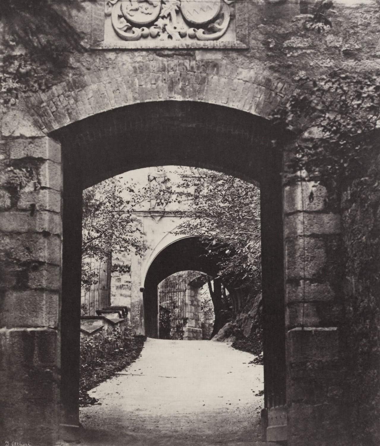A gateway arch at Hohenschwangau Castle in an early photograph, a second arch beyond it and a track running through both A gateway arch at Hohenschwangau Castle in an early photograph, a second arch beyond it and a track running through both