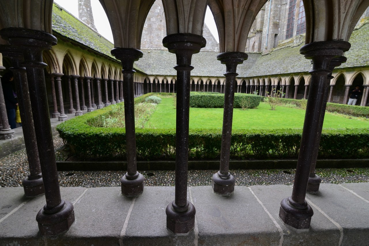 The cloister of Mont-Saint-Michel, a double row of slender offset columns around a green garth The cloister of Mont-Saint-Michel, a double row of slender offset columns around a green garth