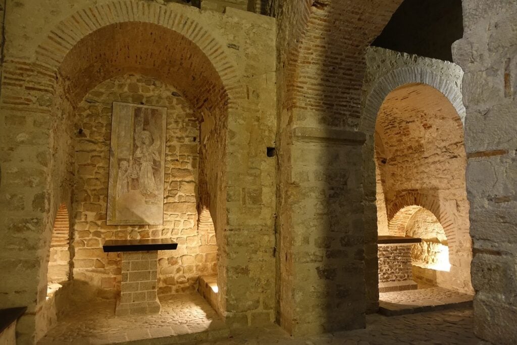 Mont-Saint-Michel 20 The chapel of Notre-Dame-sous-Terre, with twin arches turned in rough stone and brick flanking a heavy central pier