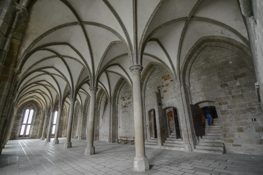 Mont-Saint-Michel 15 The Salle des Hôtes, a Gothic hall with ribbed vaults springing from a row of slender columns