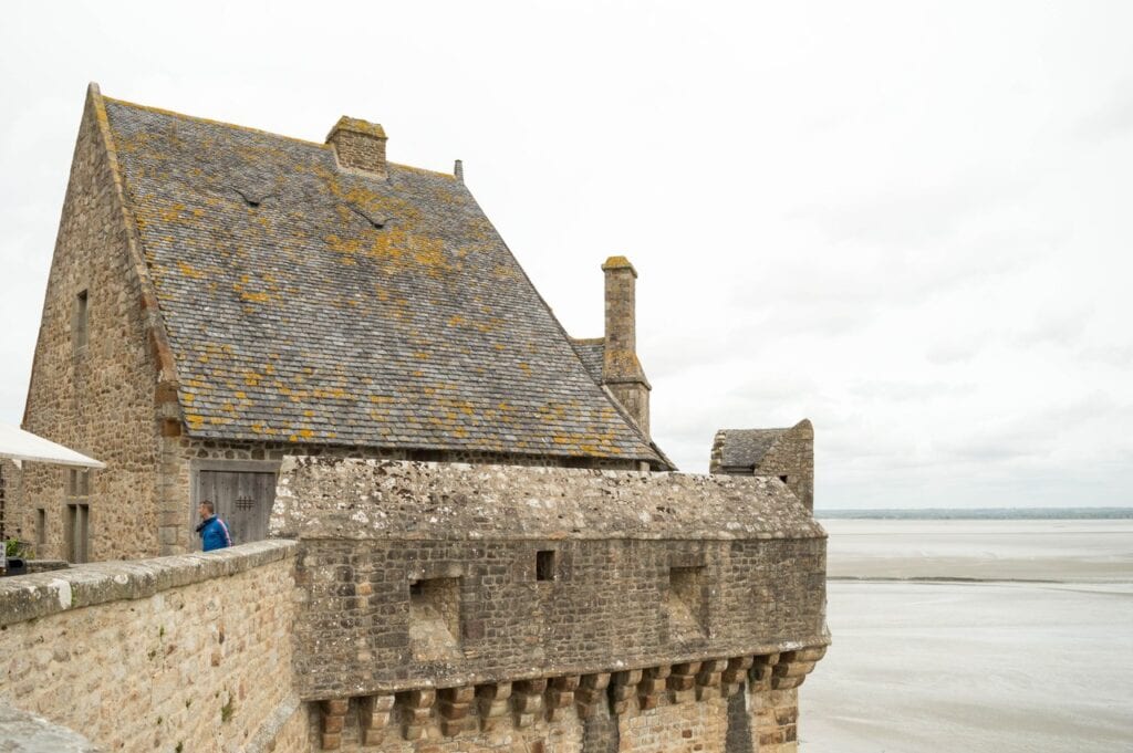 Mont-Saint-Michel 5 The tour Boucle, a slate-roofed structure on a round machicolated stone base projecting from the town wall above sand
