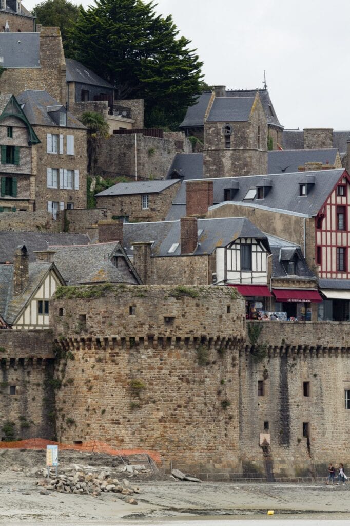 Mont-Saint-Michel 6 The round tour de la Liberté on the town wall, village houses stacked on the slope behind