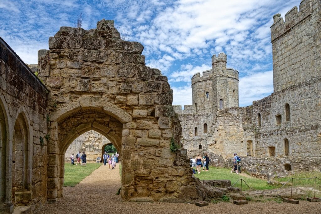 Pointed stone doorway inside Bodiam Castle courtyard framing a view of the curtain towers
